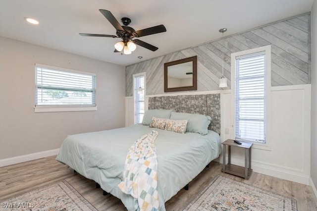 bedroom with wood-type flooring and ceiling fan