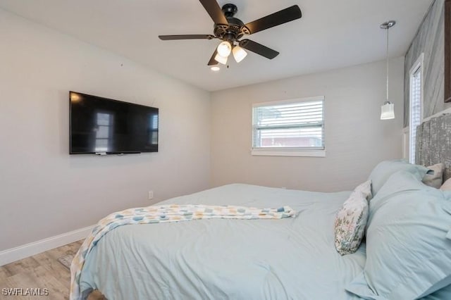 bedroom with ceiling fan and light hardwood / wood-style floors