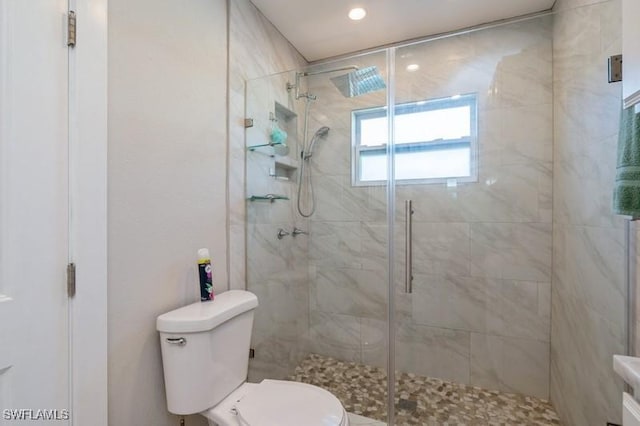 bathroom with an enclosed shower and toilet