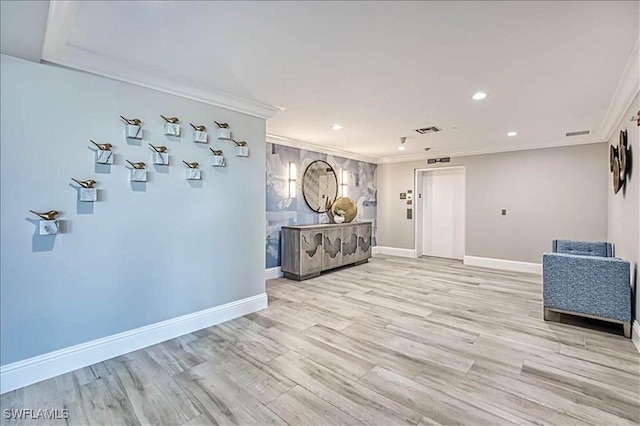 unfurnished room featuring elevator, light hardwood / wood-style flooring, and crown molding