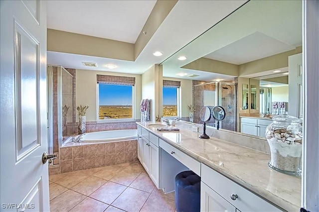 bathroom with tile patterned flooring, vanity, and separate shower and tub