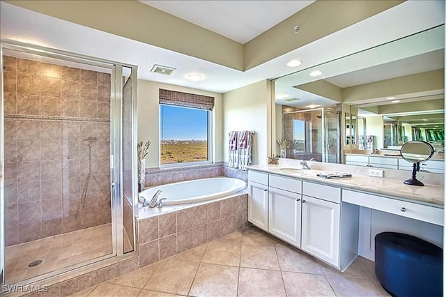 bathroom with tile patterned flooring, vanity, and independent shower and bath