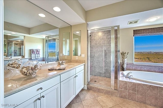 bathroom featuring tile patterned flooring, vanity, and independent shower and bath