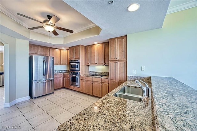 kitchen with ceiling fan, sink, stainless steel appliances, light tile patterned floors, and ornamental molding