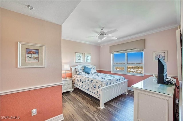 bedroom with dark hardwood / wood-style floors, ceiling fan, and crown molding