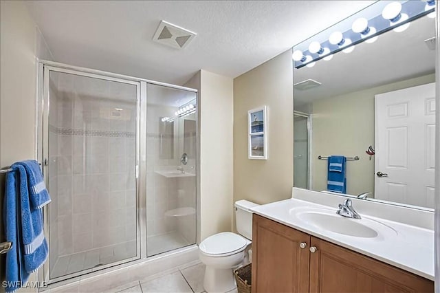 bathroom with walk in shower, a textured ceiling, vanity, tile patterned flooring, and toilet