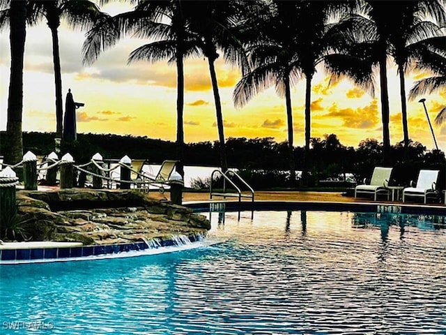 view of pool at dusk