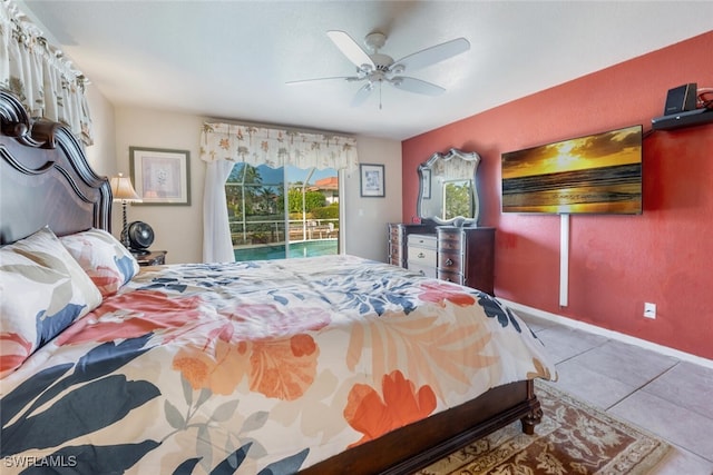 tiled bedroom with ceiling fan and access to outside