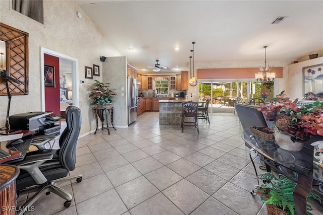 interior space featuring ceiling fan with notable chandelier