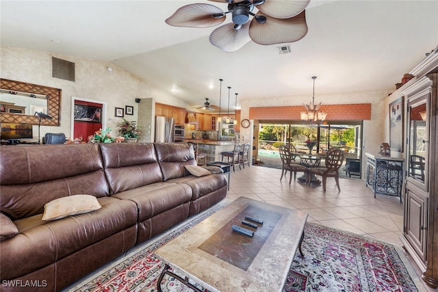 living room with lofted ceiling, light tile patterned floors, and ceiling fan with notable chandelier