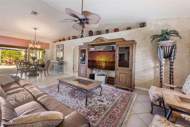 living room featuring ceiling fan with notable chandelier, light tile patterned floors, and high vaulted ceiling