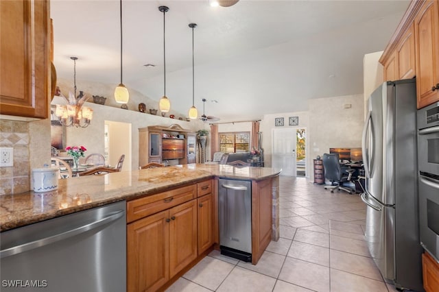 kitchen with light stone countertops, stainless steel appliances, kitchen peninsula, decorative light fixtures, and light tile patterned floors