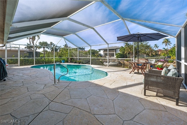 view of swimming pool with a patio area and glass enclosure