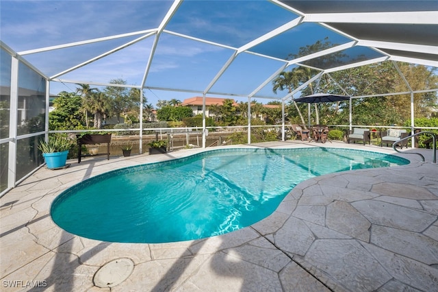 view of pool with a lanai and a patio area