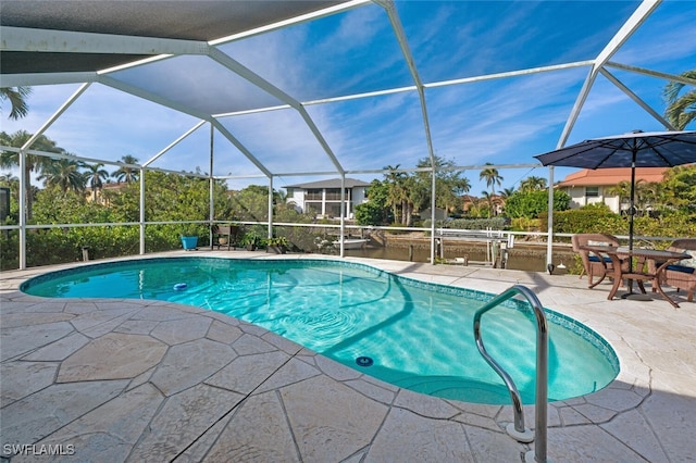 view of swimming pool featuring a lanai and a patio area