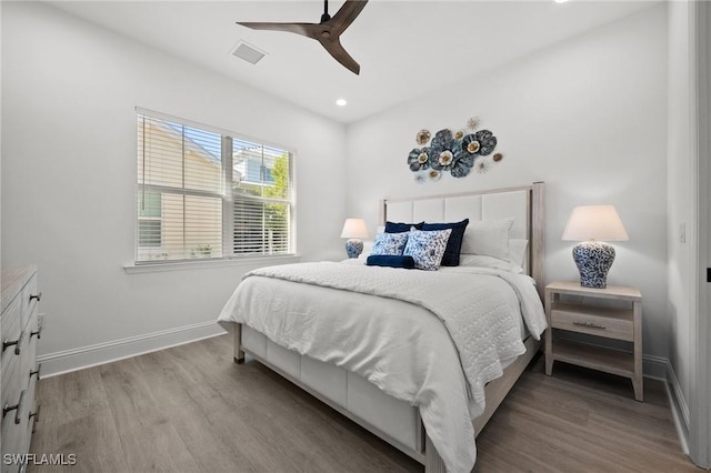 bedroom with ceiling fan and light hardwood / wood-style flooring