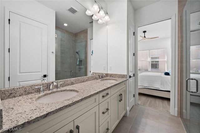 bathroom featuring an enclosed shower, vanity, tile patterned floors, and ceiling fan