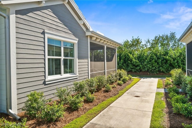 view of side of home featuring a sunroom