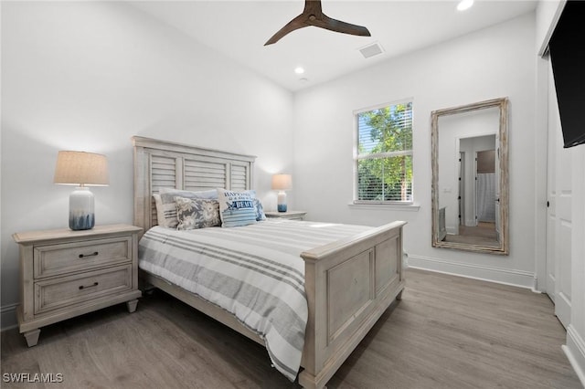 bedroom with ceiling fan and hardwood / wood-style flooring