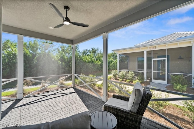 sunroom with a wealth of natural light and ceiling fan