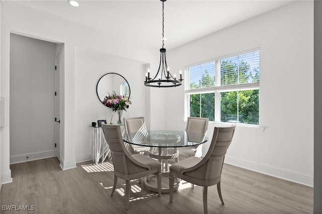 dining room featuring dark hardwood / wood-style floors and a chandelier