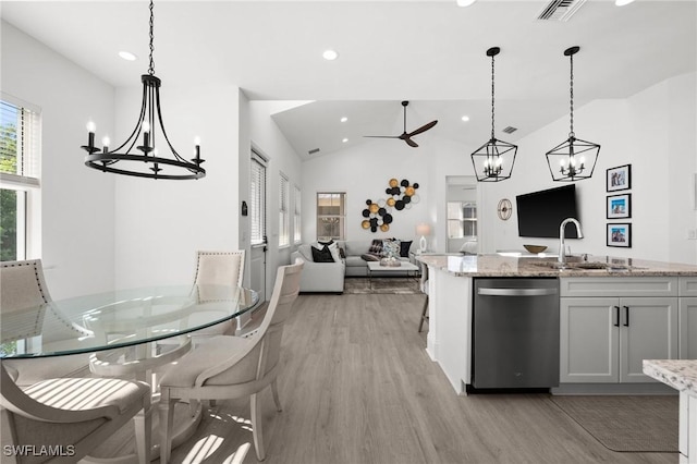 kitchen featuring stainless steel dishwasher, ceiling fan, white cabinetry, hanging light fixtures, and lofted ceiling