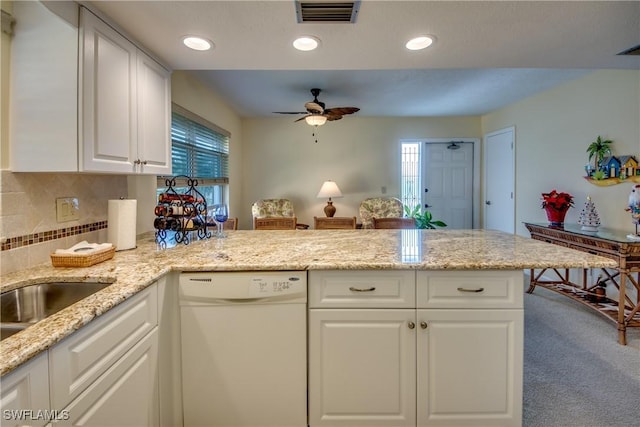 4026 SE 12th Ave Unit 208, Cape Coral, FL 33904 - kitchen featuring white dishwasher, a ceiling fan, white cabinetry, tasteful backsplash, and a peninsula