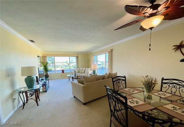 living room with baseboards, visible vents, light colored carpet, ornamental molding, and a textured ceiling