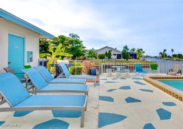 view of swimming pool featuring a patio area and fence