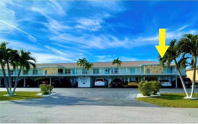 view of building exterior with covered parking