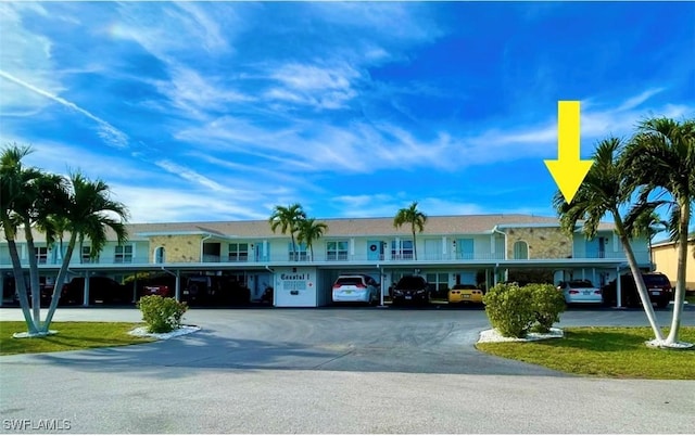 view of building exterior featuring covered parking