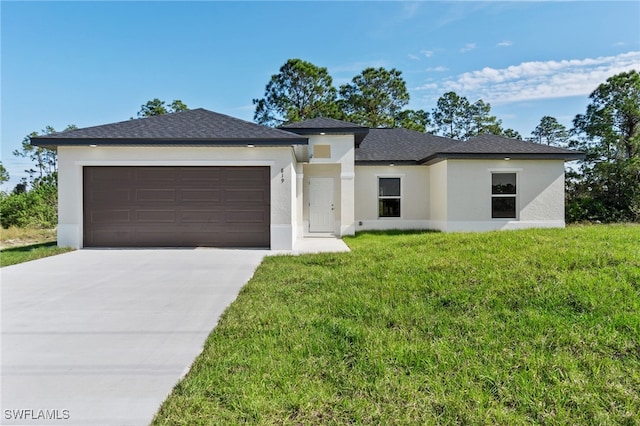 view of front facade with a garage and a front yard