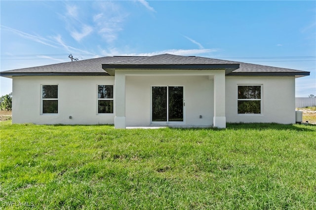 rear view of house with a yard