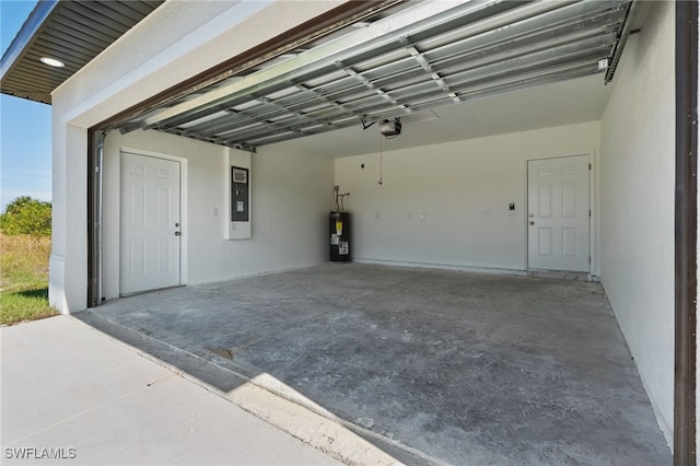 garage featuring water heater and a garage door opener