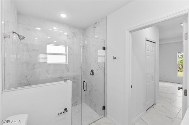 bathroom featuring a shower with shower door