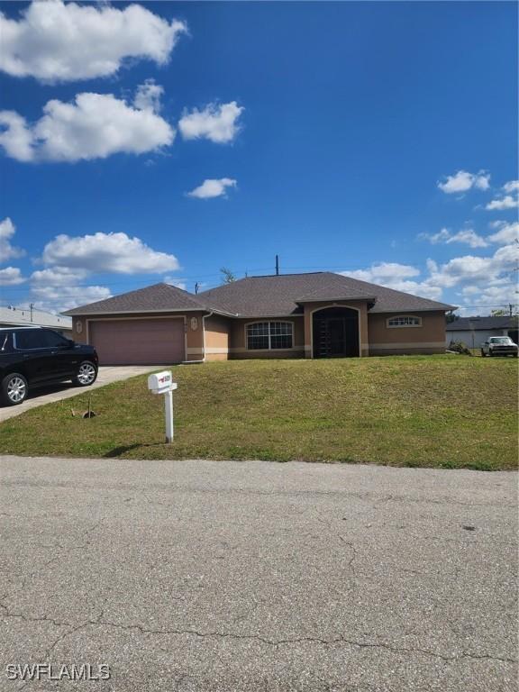 view of front facade with a front lawn and a garage