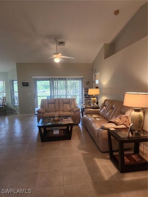 tiled living room featuring ceiling fan and vaulted ceiling