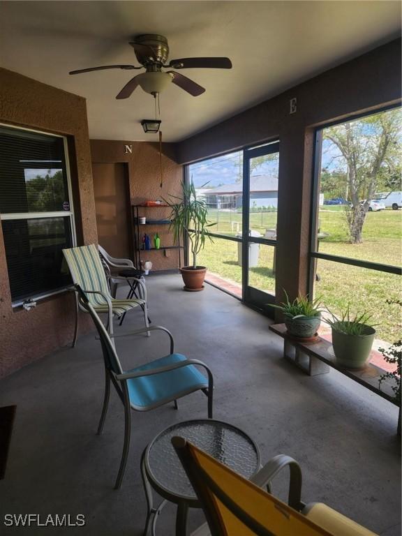 sunroom featuring a wealth of natural light and ceiling fan