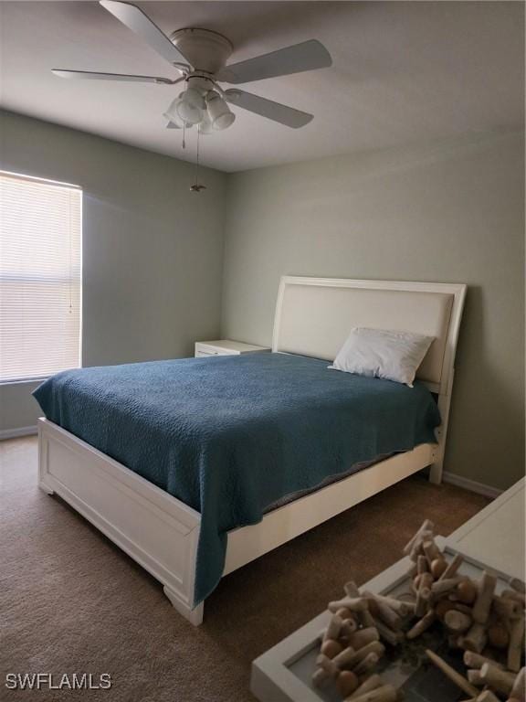 bedroom with dark colored carpet and ceiling fan