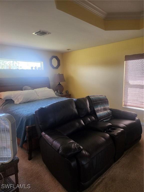 carpeted bedroom with ornamental molding