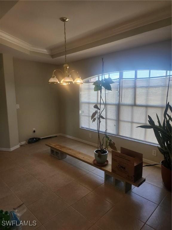 unfurnished dining area with tile patterned flooring, a raised ceiling, and a healthy amount of sunlight