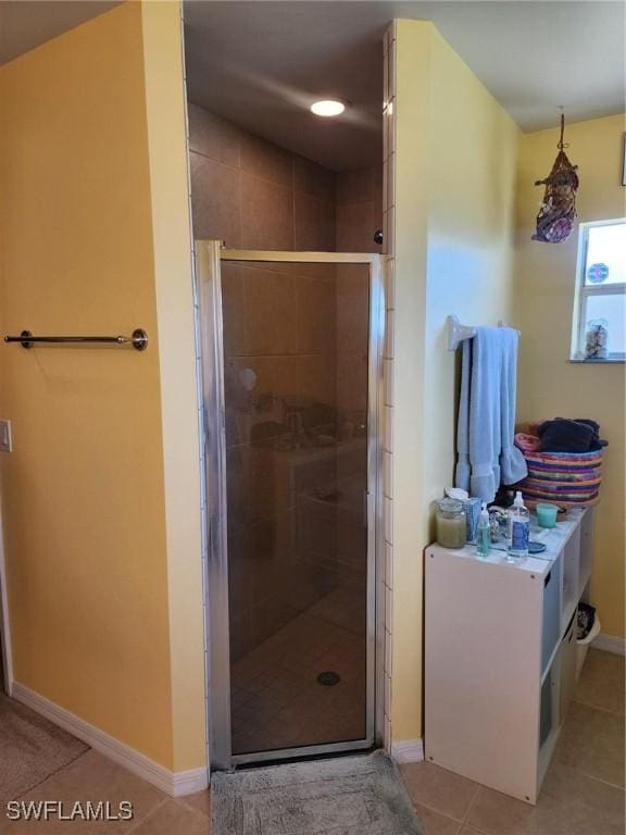 bathroom featuring tile patterned floors and an enclosed shower