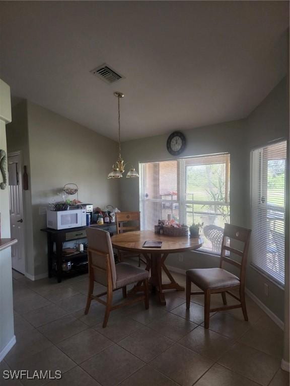 tiled dining area with a notable chandelier