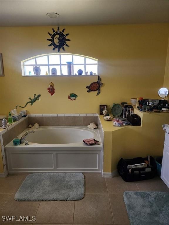 bathroom with tile patterned flooring, a bathtub, and a wealth of natural light