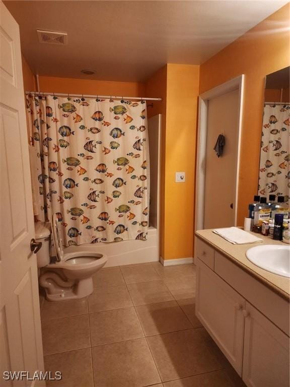 full bathroom with tile patterned floors, shower / bath combo, toilet, and vanity