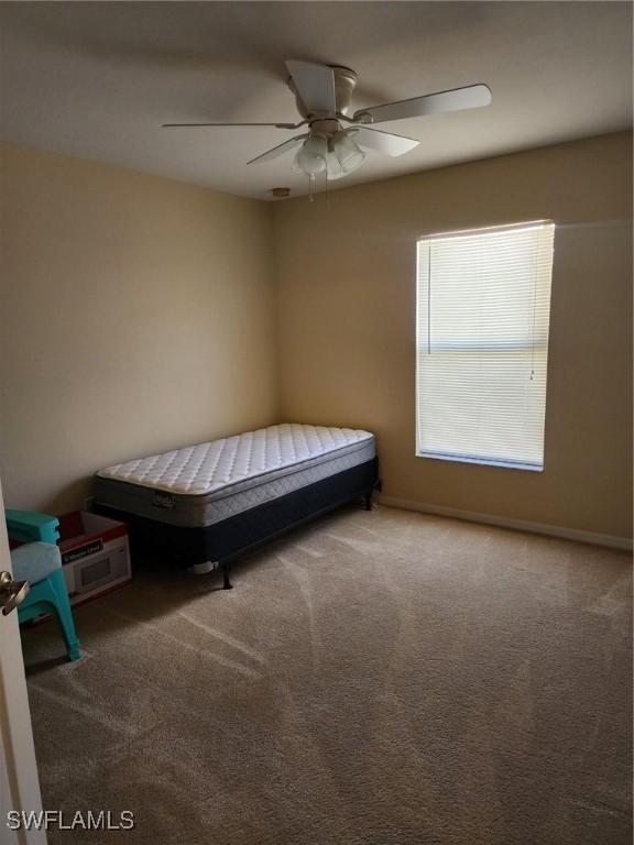 unfurnished bedroom with carpet flooring and ceiling fan