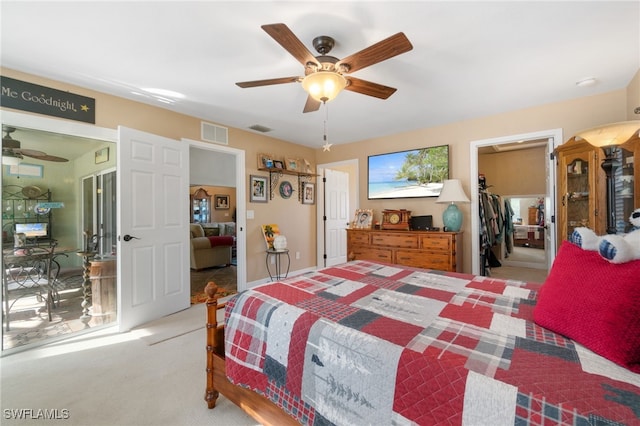 carpeted bedroom featuring ceiling fan, a spacious closet, and a closet