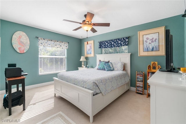 bedroom with ceiling fan and light carpet