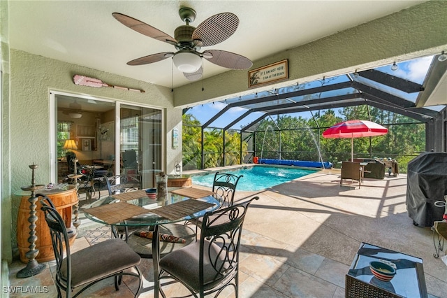 view of pool featuring a lanai, a patio area, and ceiling fan