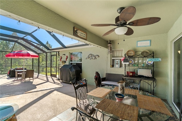 view of patio / terrace featuring ceiling fan, area for grilling, and a lanai